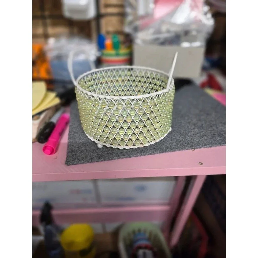 Metal basket with iridescent beads all around